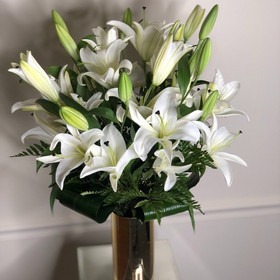 White lilies in a gold vase